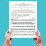 A blue background with an executive assistant resume template being help up by two hands