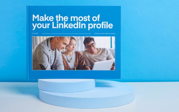 A blue book on a blue stand with a blue background. The book is called Make the most of your LinkedIn profile.